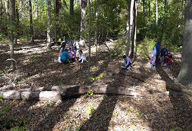  Butler students digging in dirt to learn about soil